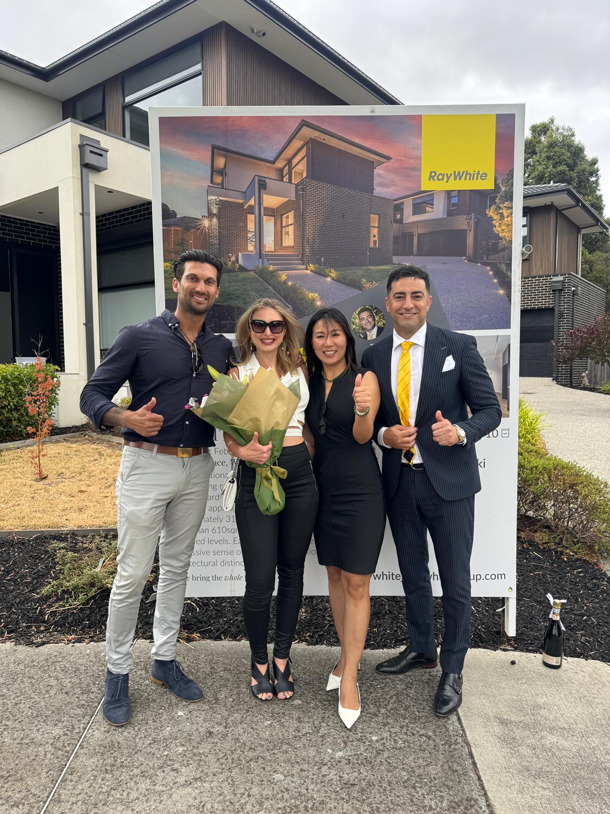 Happy vendors celebrate a sold result with their Ray White agent